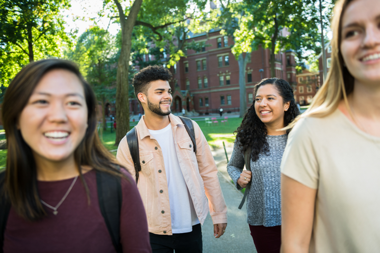 Students walking around campus smiling