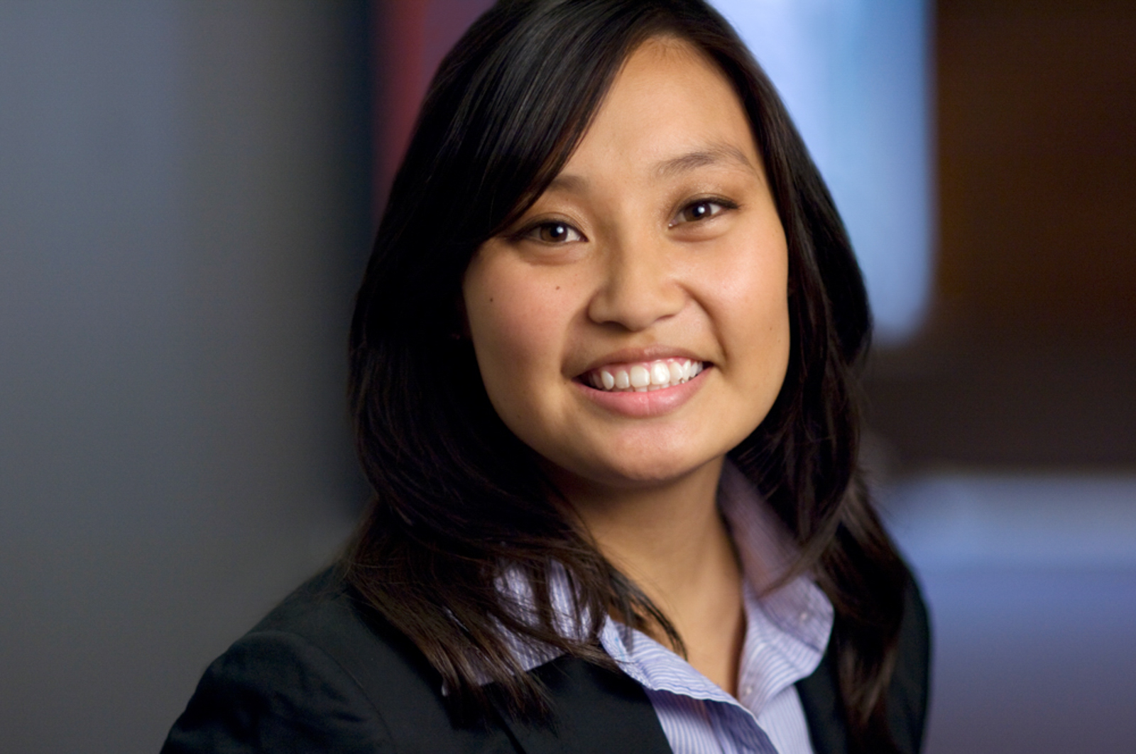 Portrait of young woman smiling in office setup