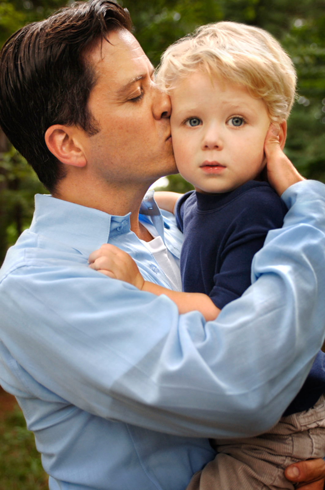 Portrait of man holding a small child lovingly
