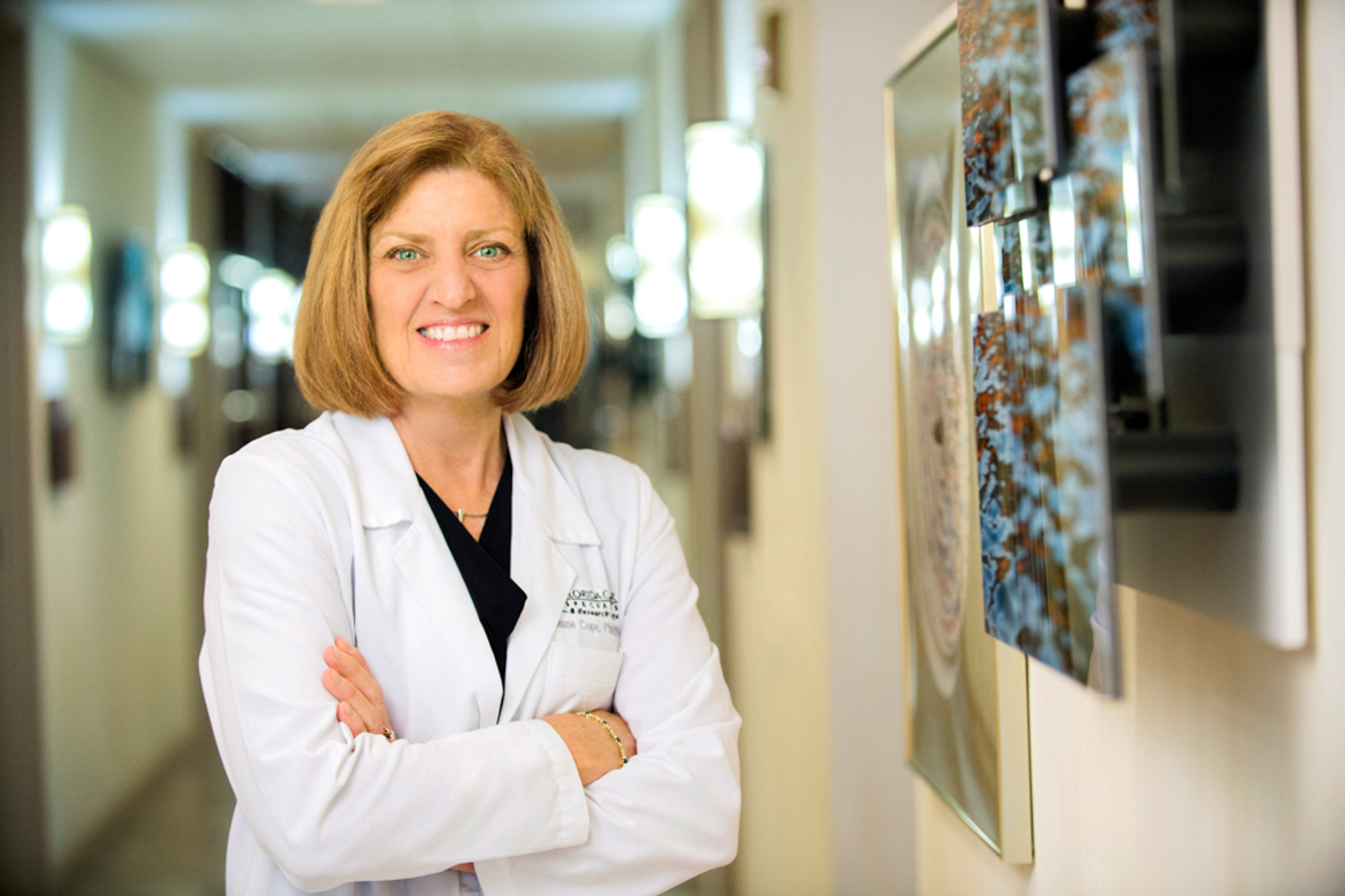 Portrait of health professional with her armed crossed smiling in hallway