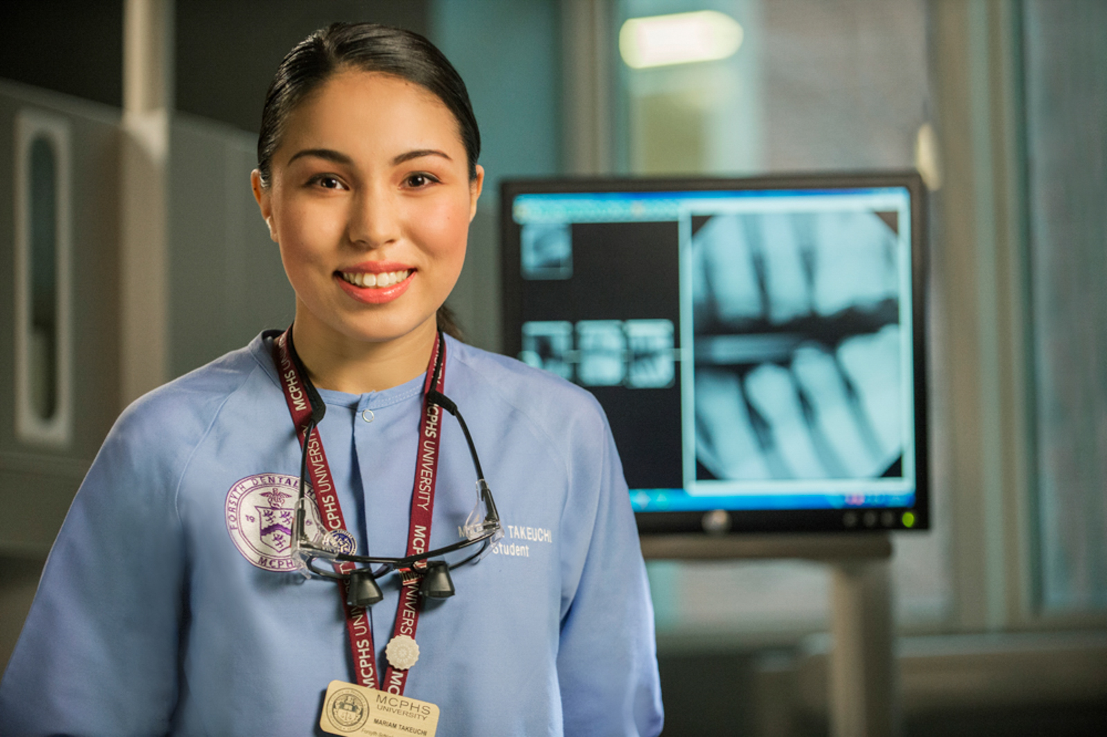 Portrait of female medical student in front of monitor with xrays