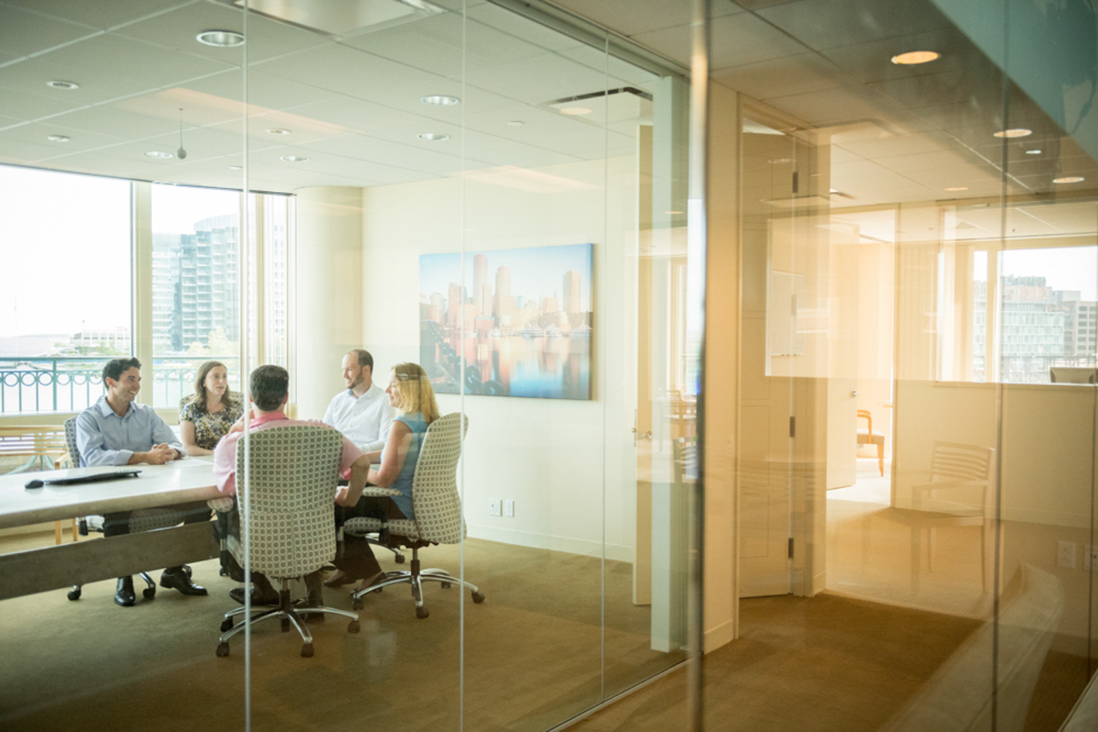 Image of an office meeting seen through a window
