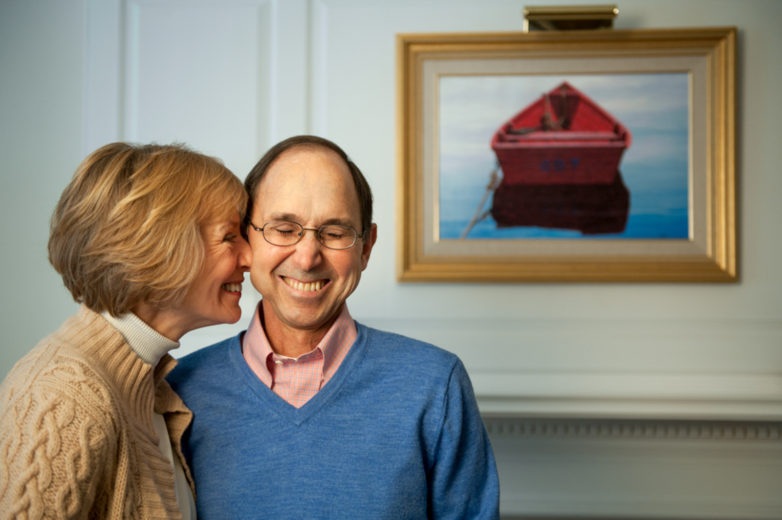 Portrait of smiling couple in a loving moment with painting