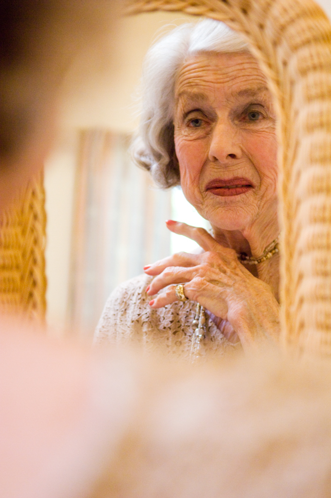Portrait of elegant elderly woman staring at the mirror